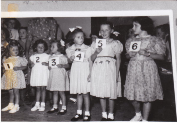 Copy of children lined up with some numbers 1 &ndash; 6 perhaps the result of a competition